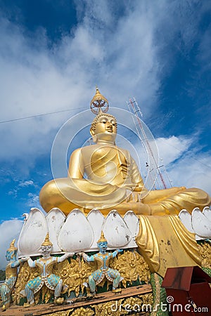 Big Golden Buddha statue against blue sky in Tiger Cave temple Stock Photo