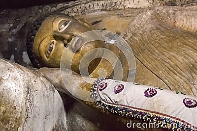 Big golden Buddha statue inside of Dambulla cave temple Stock Photo
