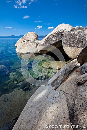Big granite boulders at pristine lake shore Stock Photo