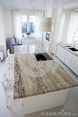 Big granitic worktop in bright kitchen Stock Photo