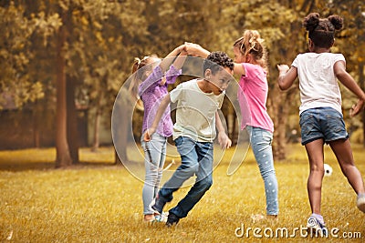 Medium group of children playing at public park. Stock Photo