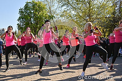 Feel Empowered and Energized: Join a Dynamic Piloxing Session with a Group of Energetic Women in Pink T-Shirts! Editorial Stock Photo