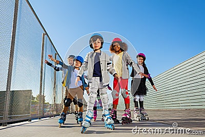 Preteen kids rollerblading outdoors at stadium Stock Photo