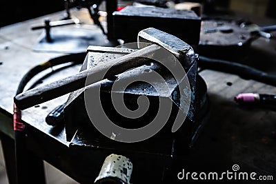 Big hammer on anvil in blacksmith workshop Stock Photo