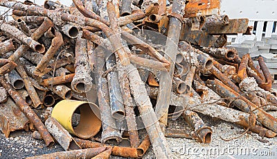 Big heap of iron scrap on the street, with corroded pipes Stock Photo