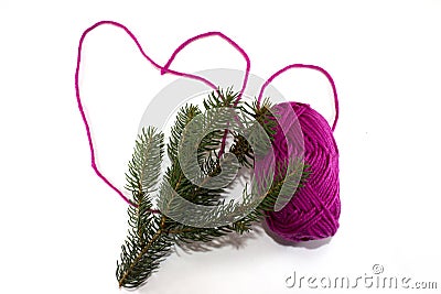 Big heart made of purple skein of thread with pine branch Stock Photo