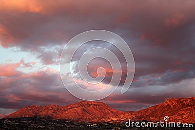 Big huge sunset clouds over the red mountains in Tucson Arizona Stock Photo