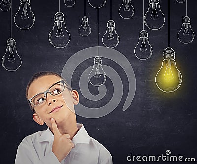 Big idea. Smart boy with solution lightbulb Stock Photo