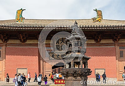 Big iron burner in front of Mahavira or Great Hall at Upper Huayan Monaster Editorial Stock Photo