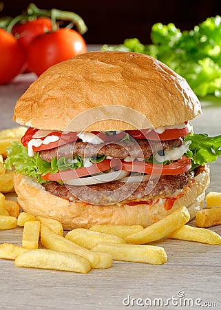 Big juicy double burger with french fries Stock Photo