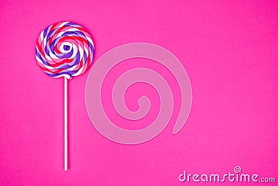 Big lollipop on solid pink background Stock Photo