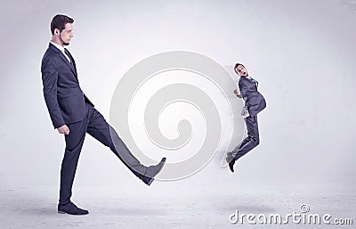 Big man kicking little himself out Stock Photo