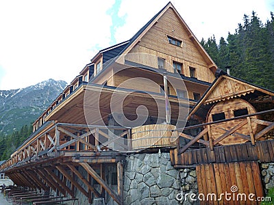 Big mountain hut with terrace and wooden facade Stock Photo