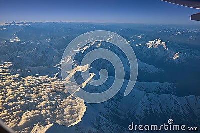 The big mountains separate the clouds. During the fly to China Stock Photo