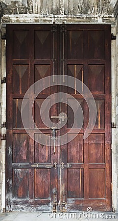 Big old wooden door with peeling varnish Stock Photo