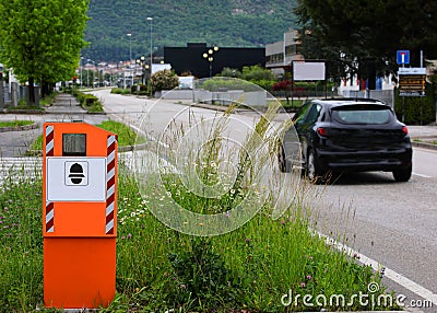 Big orange Safety Speed Camera and a black car on the road Stock Photo