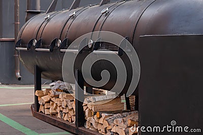 Big outdoor commercial grill with firewood at summer local food festival Stock Photo