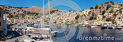 Big panorama view on Greek sea Symi island harbor port, houses on island hills. Editorial Stock Photo