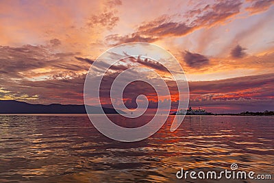 Big passenger ferry ship on sunset background in Vlore city port. Wonderful sunset on Adriatic Sea in western Albania, Europe. Stock Photo