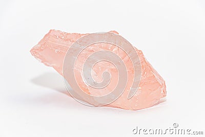 Big piece of rose quartz SiO2 unpolished with uneven shiny surfaces on white background Stock Photo