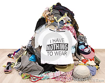 Big pile of clothes thrown on the ground with a t-shirt saying nothing to wear. Stock Photo