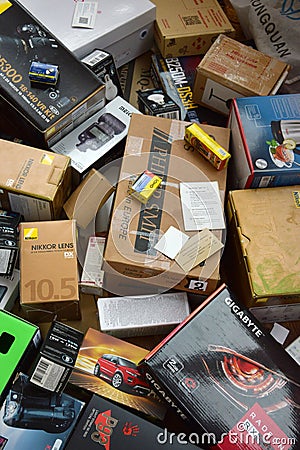 Big pile of many cardboard boxes from electronic products of famous manufacturers. Disposable wrappings of domestic use goods. Editorial Stock Photo