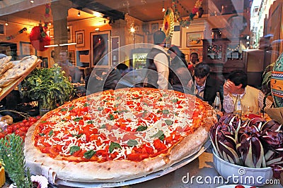 Big pizza displayed in restaurant window in Venice, Italy. Editorial Stock Photo