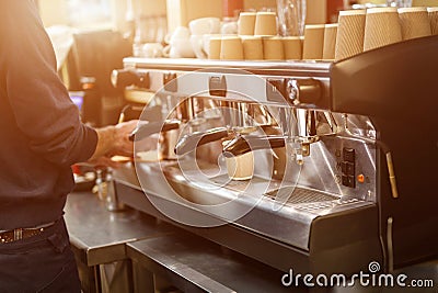 Big professional coffee machine. Barista preparing coffee at cafe or restaurant. Hot drink to go. Warm and friendly ambience. Good Stock Photo