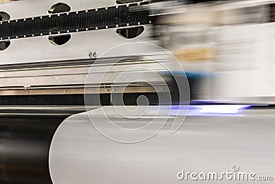 Big professional printer, processing massive vinyl rolls. Stock Photo