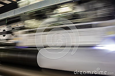 Big professional printer, processing massive vinyl rolls. Stock Photo