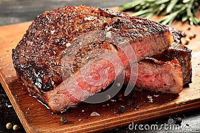 Medium Rare Ribeye steak on wooden board, selected focus Stock Photo
