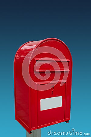 Big red postbox with white empty note space for address at gradient blue sky background, closeup, details Stock Photo