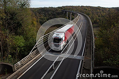A big red truck on the Chiers viaduct in Longwy in Meurthe et Moselle Editorial Stock Photo