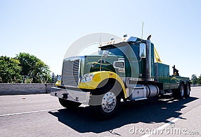 Big rig equipped towing semi truck on road Stock Photo