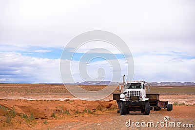 Big rig powerful semi tractor with long heavy-duty semi trailer Stock Photo