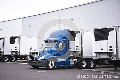 Big rig day cab semi truck and reefer trailers with refrigerator Stock Photo