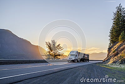 Big rig semi truck transporting boxes with apples on flat bed se Stock Photo