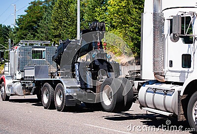 Big rig towing semi truck tow ather semi truck tractor on the road Stock Photo