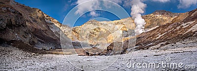 Big rocks on the eternal snow inside Mutnovsky volcano crater Stock Photo
