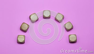 Big sad-shaped block cubes on pink background, free space for text. Stock Photo