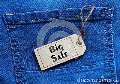 Big Sale tag on blue jean background. Stock Photo