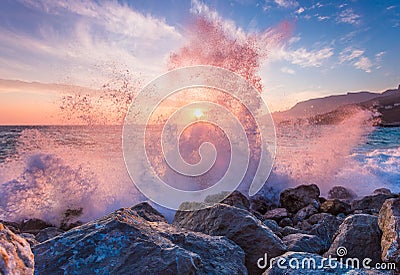 Big sea wave breaks against a stone Stock Photo