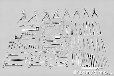 Medical instruments used for surgical operations, laid out on a gray background Stock Photo