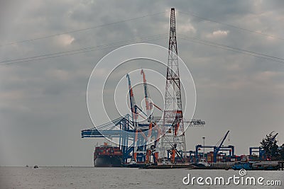 Big ship is loading containers by port cranes in Haiphong container terminal during cloudy weather Editorial Stock Photo