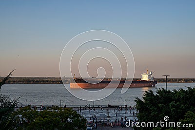 Big ship in Parana River, seen from the promenade in Rosario, Argentina during sunset Editorial Stock Photo