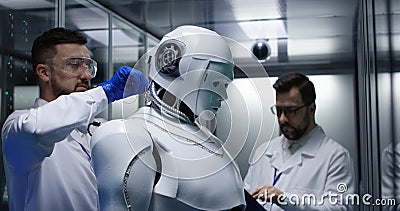 Engineers testing on robot controls Stock Photo