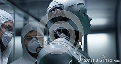 Engineer fixing wires on robot control Stock Photo