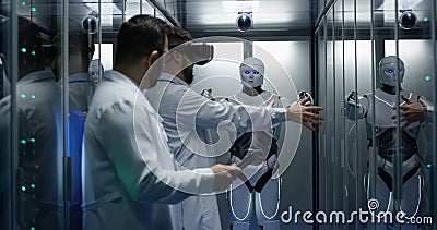 Engineers testing on robot controls Stock Photo