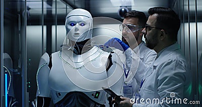 Engineers testing on robot controls inside the laboratory Stock Photo