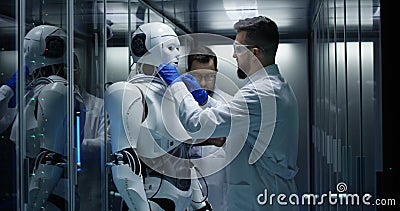 Engineers testing on robot controls inside the laboratory Stock Photo
